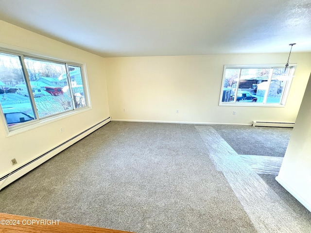 unfurnished room with a baseboard radiator and carpet floors