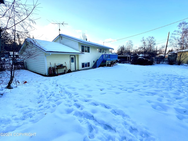 snow covered house with a deck