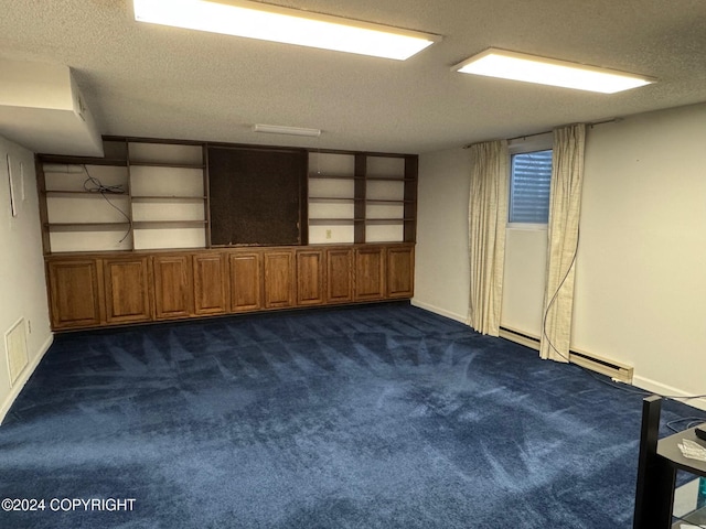 empty room featuring a textured ceiling, dark colored carpet, built in features, and baseboards