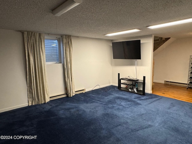 finished below grade area featuring a baseboard radiator, a textured ceiling, and baseboards