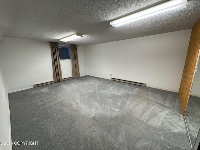 empty room featuring carpet flooring, a textured ceiling, and baseboard heating