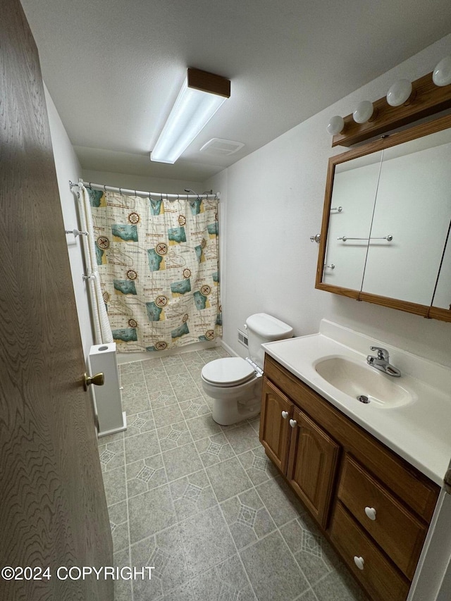 full bathroom featuring vanity and toilet