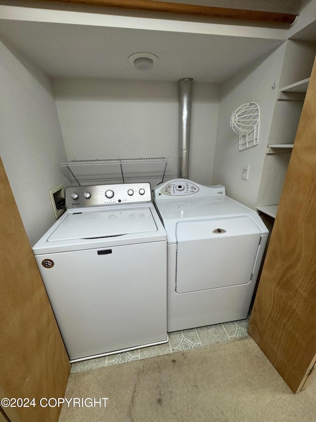 laundry room featuring light carpet, laundry area, and washing machine and clothes dryer