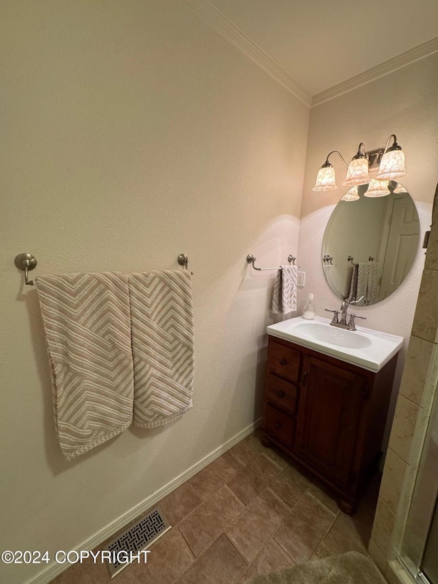 bathroom with baseboards, crown molding, and vanity