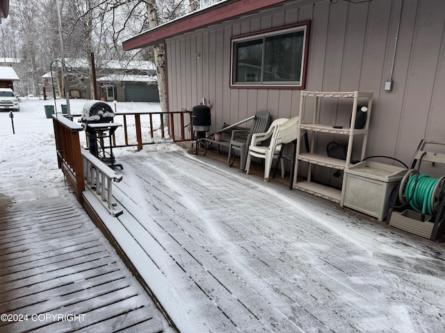 snow covered deck featuring area for grilling