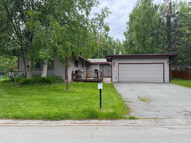 6921 Dickerson Dr, Anchorage, AK 99504 - view of front facade featuring a front yard, asphalt driveway, and a garage