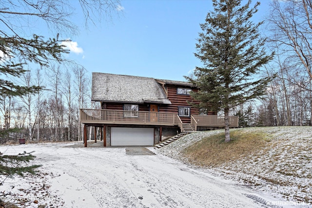 view of front of property featuring a deck and a garage