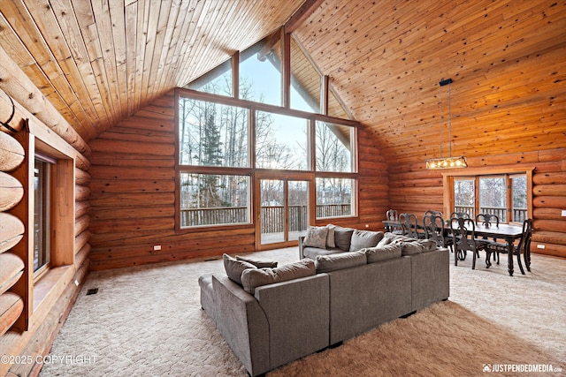 carpeted living room with high vaulted ceiling, wooden ceiling, log walls, and a chandelier