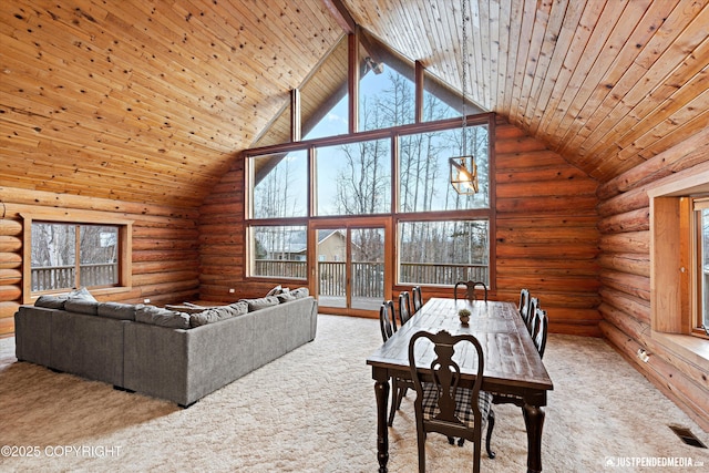 carpeted living room with wooden ceiling, beamed ceiling, log walls, and high vaulted ceiling