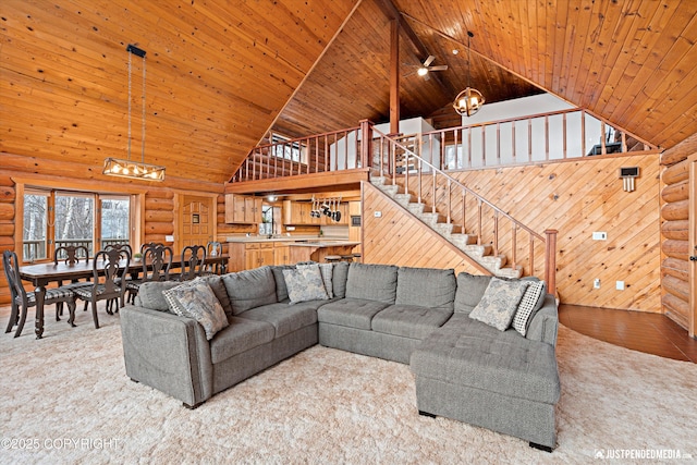 living room with log walls, wood ceiling, ceiling fan, high vaulted ceiling, and light colored carpet