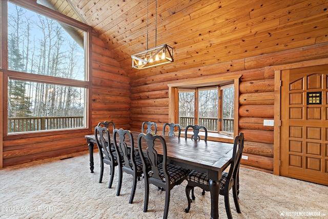 dining space with high vaulted ceiling, wooden ceiling, rustic walls, and light carpet