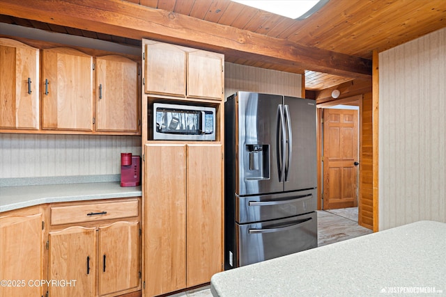 kitchen with wooden ceiling, appliances with stainless steel finishes, and beamed ceiling