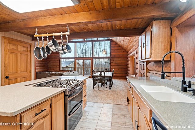 kitchen with beam ceiling, double oven range, rustic walls, and sink