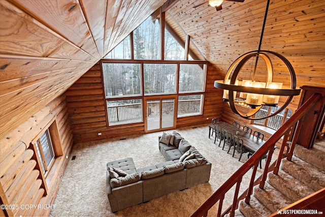 unfurnished living room with high vaulted ceiling, rustic walls, and wooden ceiling