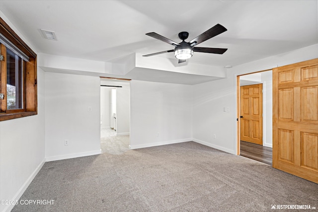 carpeted spare room featuring ceiling fan