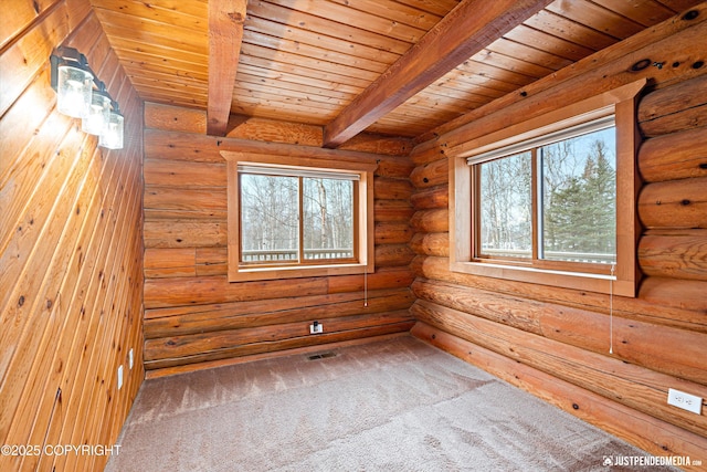 spare room with wooden ceiling, beamed ceiling, rustic walls, and carpet flooring