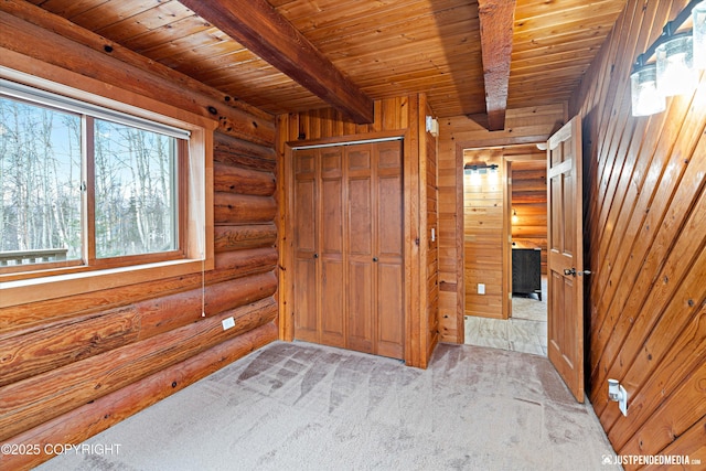 carpeted bedroom with rustic walls, wood ceiling, a closet, and beamed ceiling