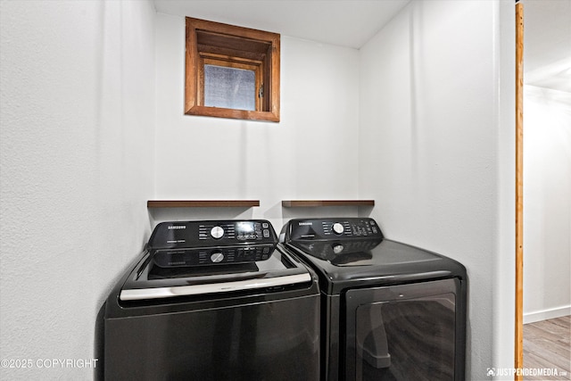 washroom featuring hardwood / wood-style flooring and washer and clothes dryer