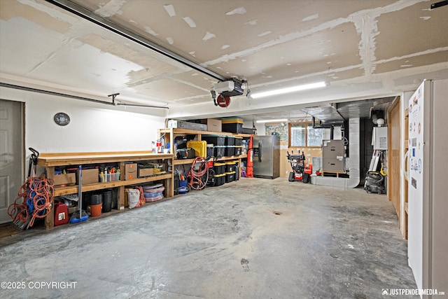 garage with stainless steel fridge, heating unit, a garage door opener, and a workshop area