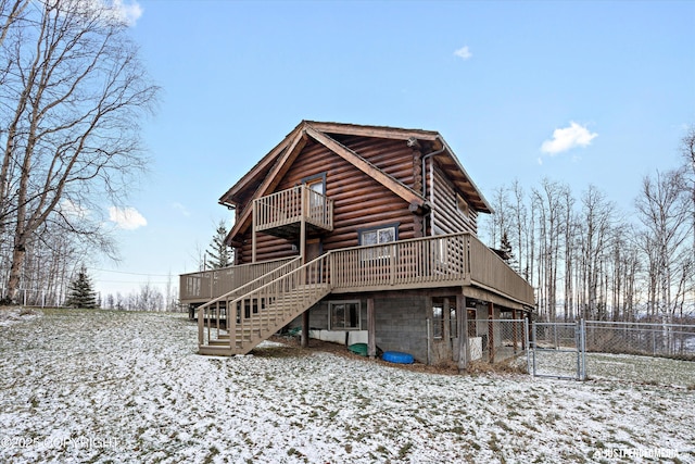 snow covered property featuring a deck