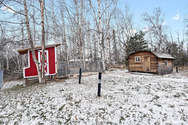 snowy yard with a storage unit