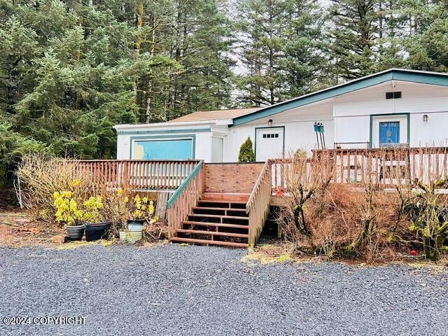 view of front of home featuring stairway and a deck