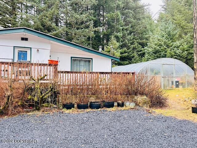 3411 Monashka Bay Rd, Kodiak, AK 99615 - view of property exterior with a greenhouse and an outdoor structure