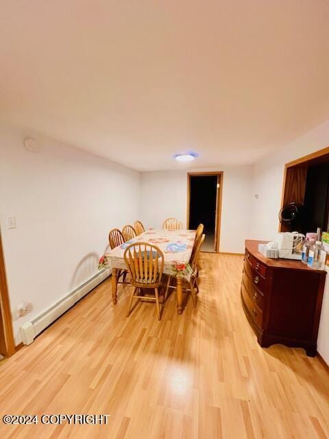 3411 Monashka Bay Rd, Kodiak, AK 99615 - dining space featuring a baseboard radiator and light wood-type flooring
