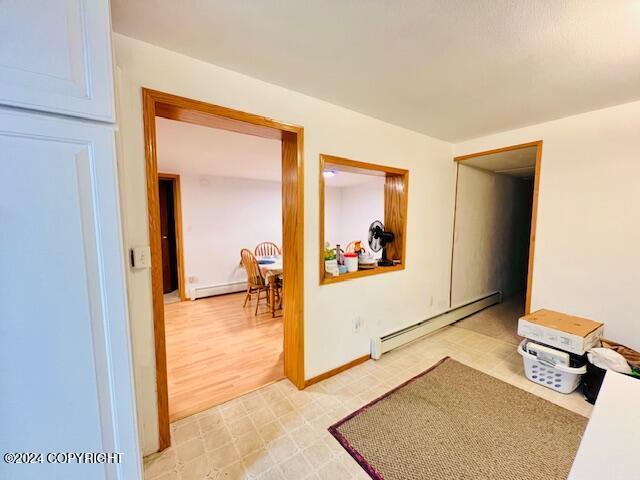 3411 Monashka Bay Rd, Kodiak, AK 99615 - hall featuring a baseboard radiator, light flooring, and a baseboard heating unit