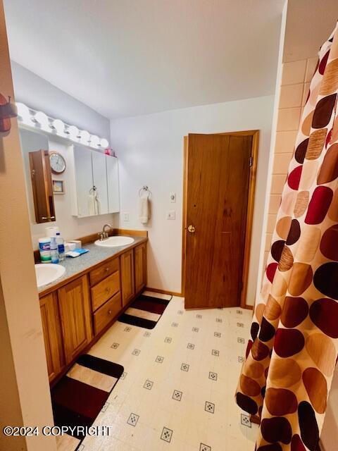 3411 Monashka Bay Rd, Kodiak, AK 99615 - bathroom with double vanity and tile patterned floors