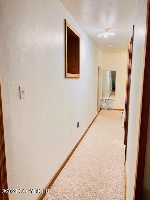 3411 Monashka Bay Rd, Kodiak, AK 99615 - hallway with light colored carpet and baseboards