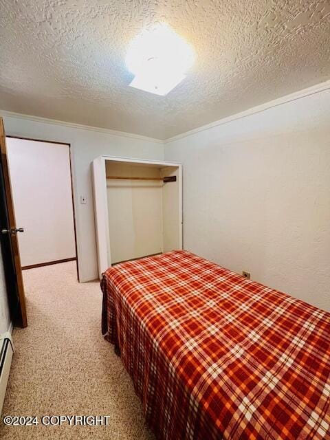 3411 Monashka Bay Rd, Kodiak, AK 99615 - bedroom featuring a textured ceiling, a closet, light colored carpet, and a baseboard radiator