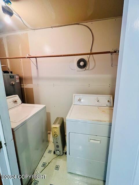 3411 Monashka Bay Rd, Kodiak, AK 99615 - laundry room featuring washing machine and dryer, water heater, and light tile patterned flooring