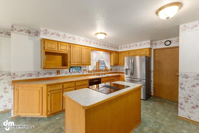 kitchen with a center island, black appliances, a textured ceiling, and sink