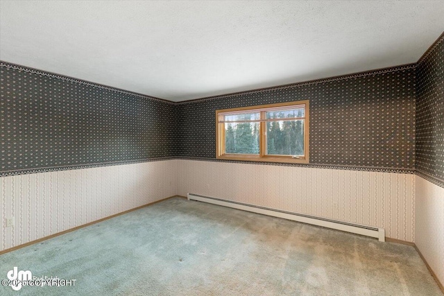 carpeted empty room featuring a baseboard radiator