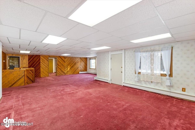 basement featuring carpet, a paneled ceiling, and baseboard heating