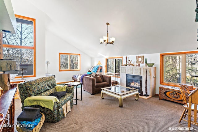 carpeted living room featuring a notable chandelier, plenty of natural light, and high vaulted ceiling