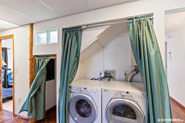 laundry room featuring dark hardwood / wood-style floors and washing machine and clothes dryer