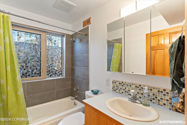 full bathroom with vanity, toilet, backsplash, and shower / tub combo with curtain