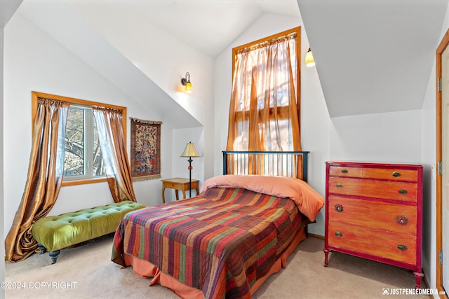 carpeted bedroom with vaulted ceiling