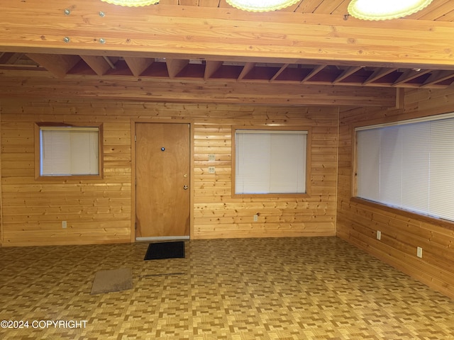 empty room with parquet floors and wooden walls