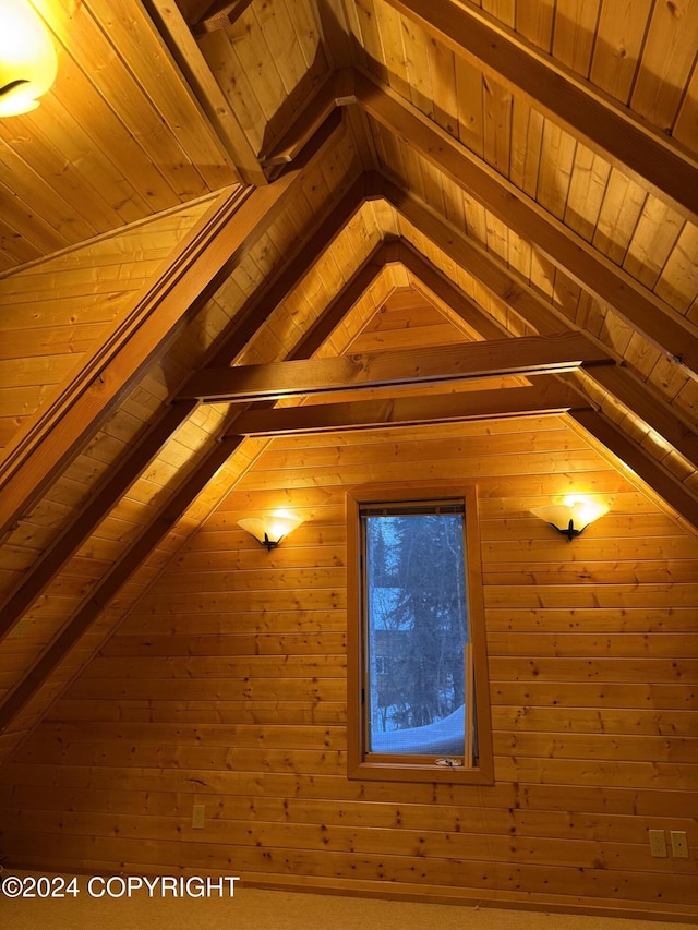 room details featuring beamed ceiling, wooden walls, and wood ceiling