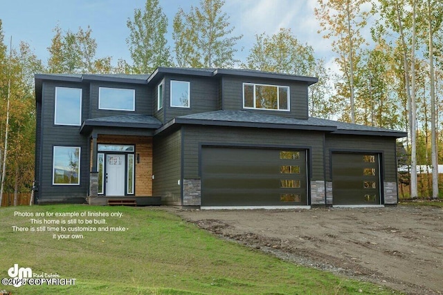 view of front of house featuring a garage and a front lawn