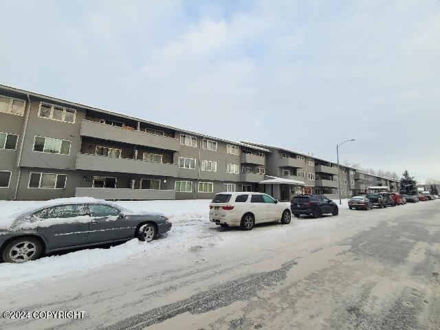 view of snow covered parking area