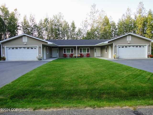 ranch-style home featuring a garage and a front lawn