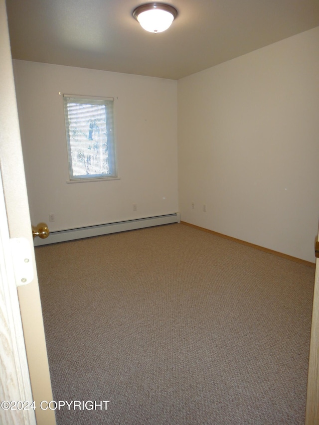 unfurnished room with carpet flooring and a baseboard radiator