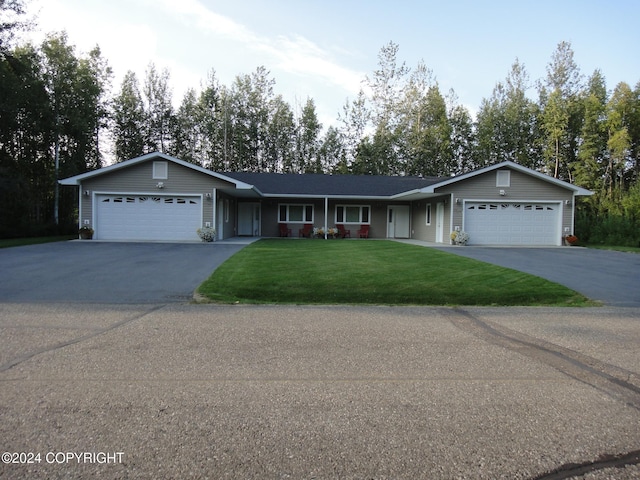 single story home featuring a garage and a front yard