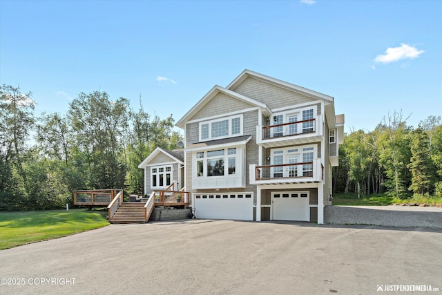 view of front facade with a front lawn, a deck, and a garage