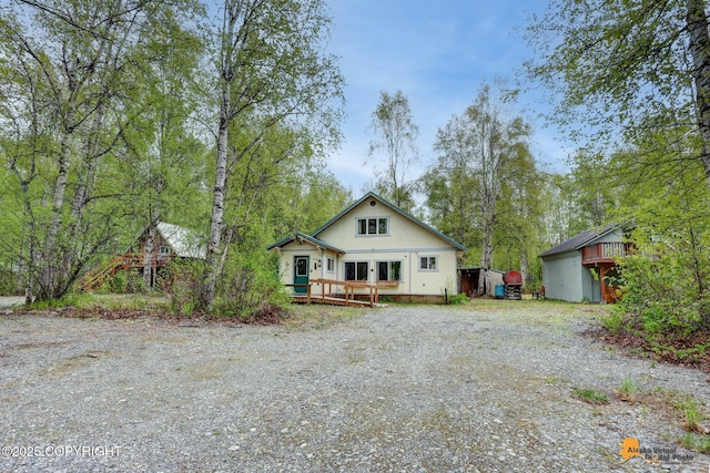 13718 E 1st St, Talkeetna, AK 99676 - bungalow-style house with a wooden deck and gravel driveway
