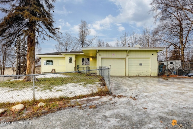 view of front facade featuring driveway, an attached garage, and fence